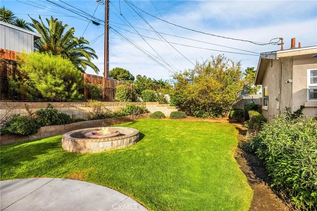 a front view of a house with a yard and potted plants