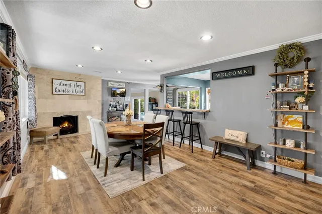 a view of a a dining room with furniture window and wooden floor