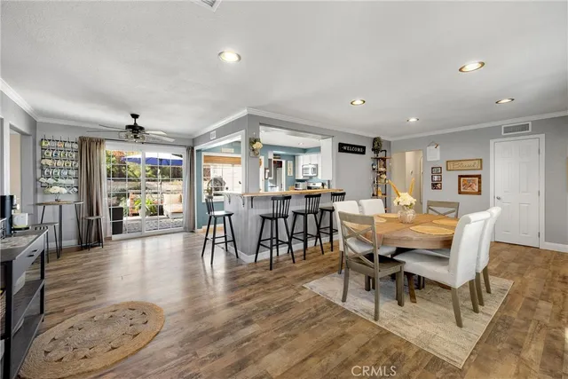 a living room with furniture dining table and a flat screen tv