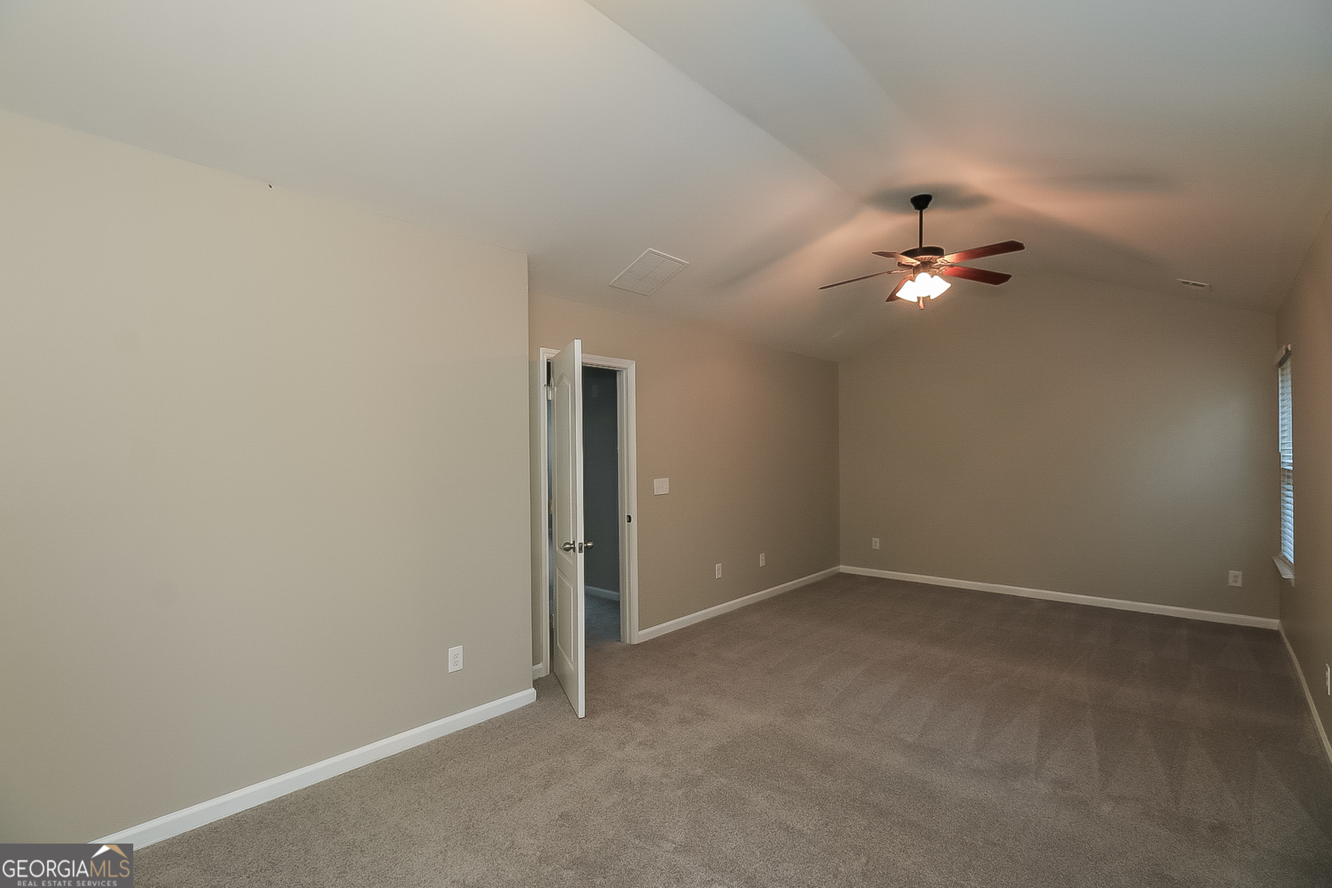 7826 Bell Tower Lane Fairburn, GA 30213 - Photo 9 of 17 an empty room with chandelier fan