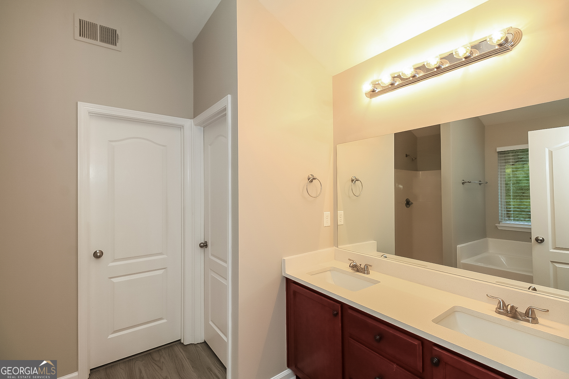 7826 Bell Tower Lane Fairburn, GA 30213 - Photo 10 of 17 a bathroom with a sink and a mirror