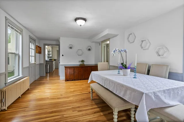 a large kitchen with sink a refrigerator and wooden floor