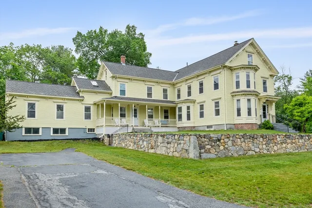 a front view of a house with a yard and swimming pool