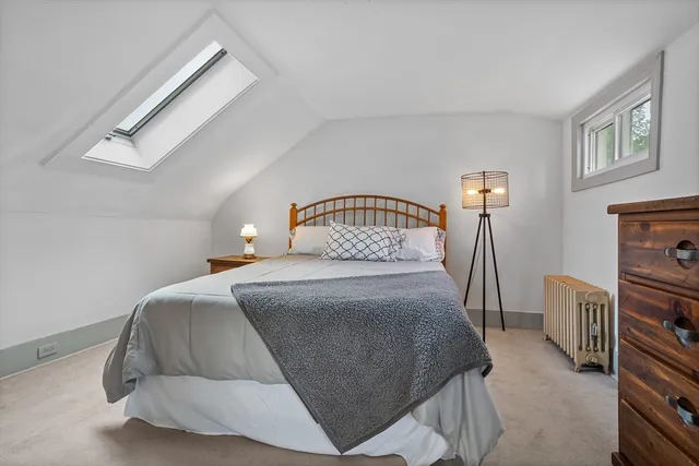 a bedroom with a bed and a fireplace