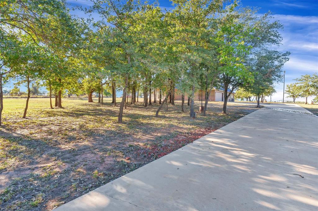 3031 Powell Cemetery Road Tolar, TX 76476 - Photo 4 of 40 a street view with large trees