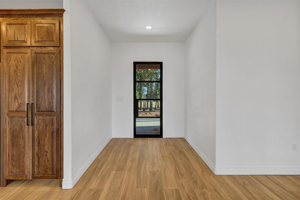 3031 Powell Cemetery Road Tolar, TX 76476 - Photo 7 of 40 a view of a room with wooden floor and closet
