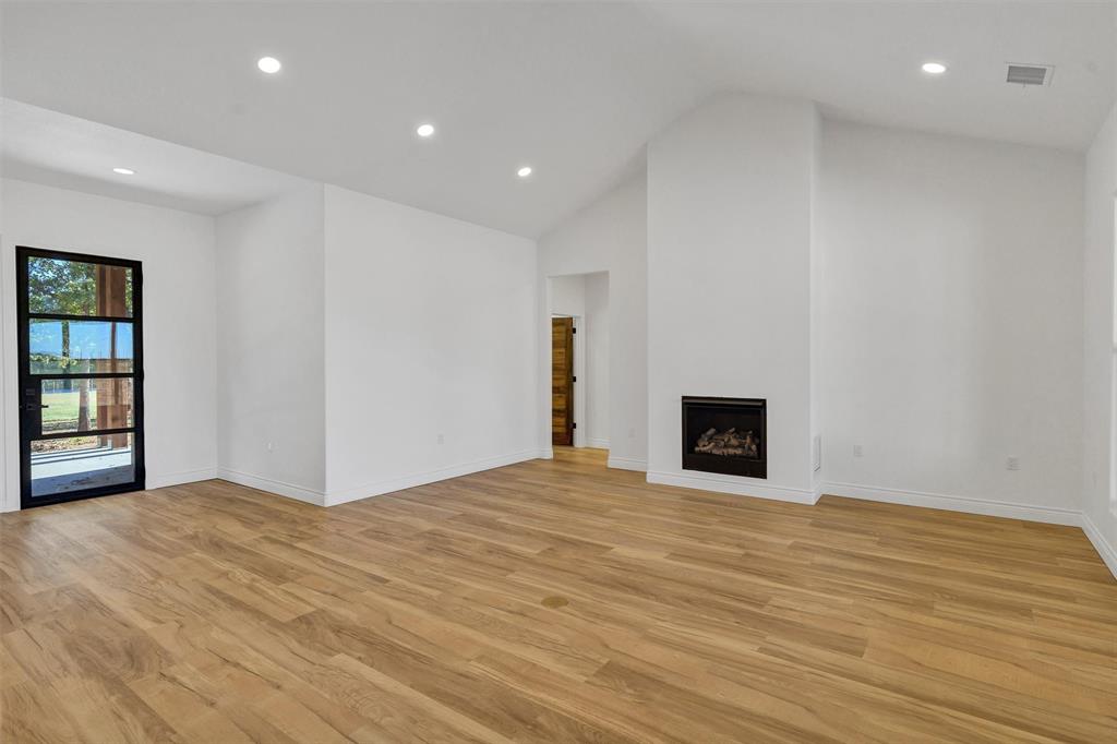 3031 Powell Cemetery Road Tolar, TX 76476 - Photo 10 of 40 a view of an empty room with wooden floor and a window