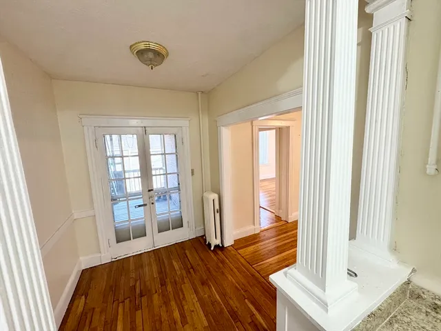 a view of front door with wooden floor