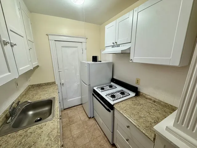 a room with microwave and cabinets