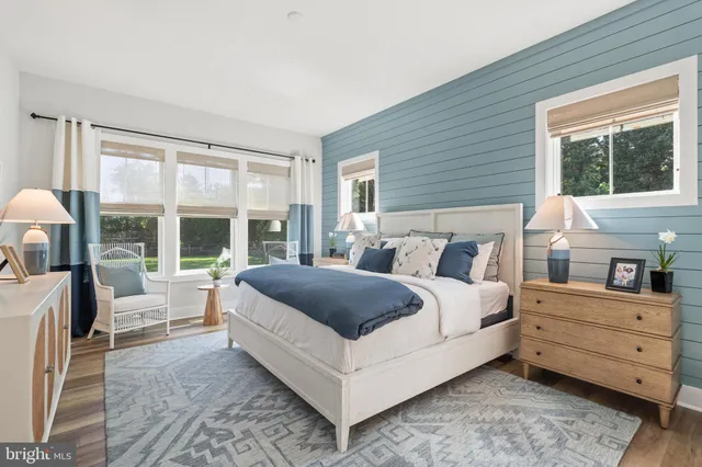 a spacious bedroom with a bed and a large window