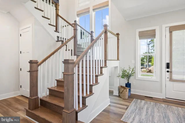 a view of entryway with wooden floor and stairs