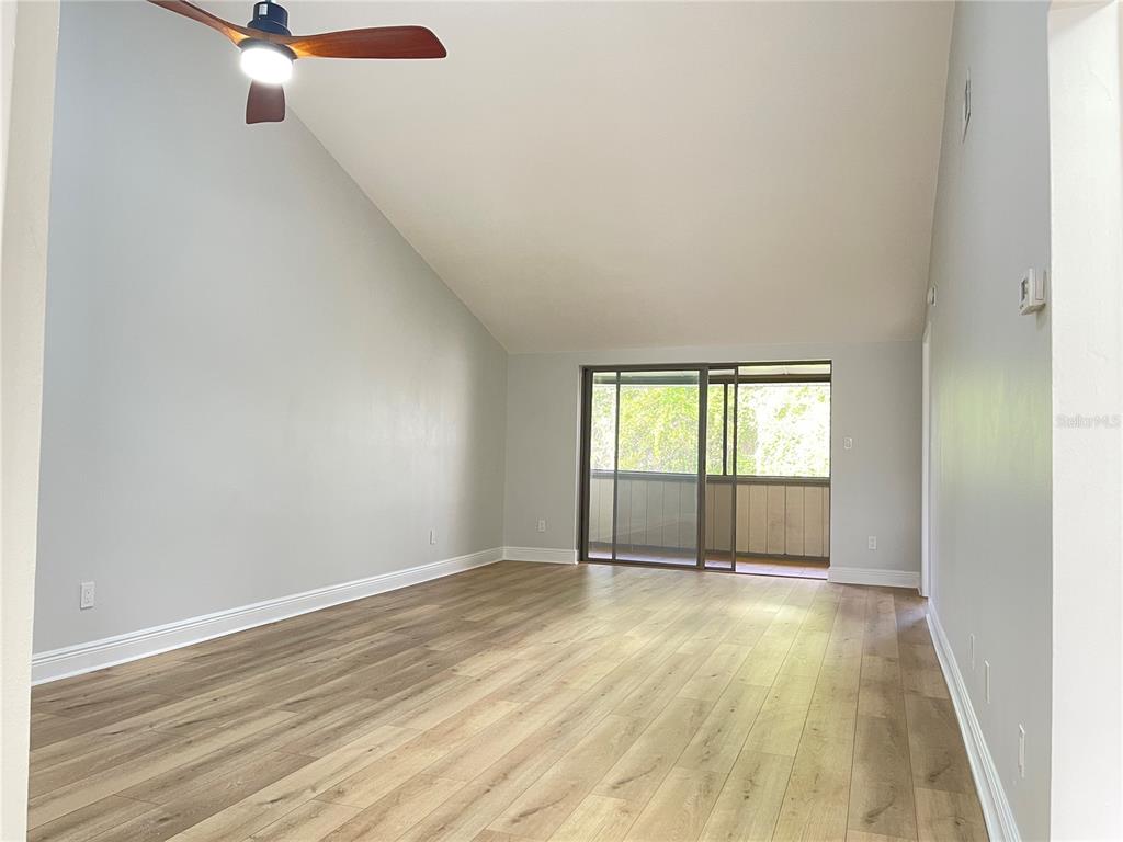 5395 Vineland Road, Unit S Orlando, FL 32811 - Photo 16 of 30 an empty room with wooden floor and windows