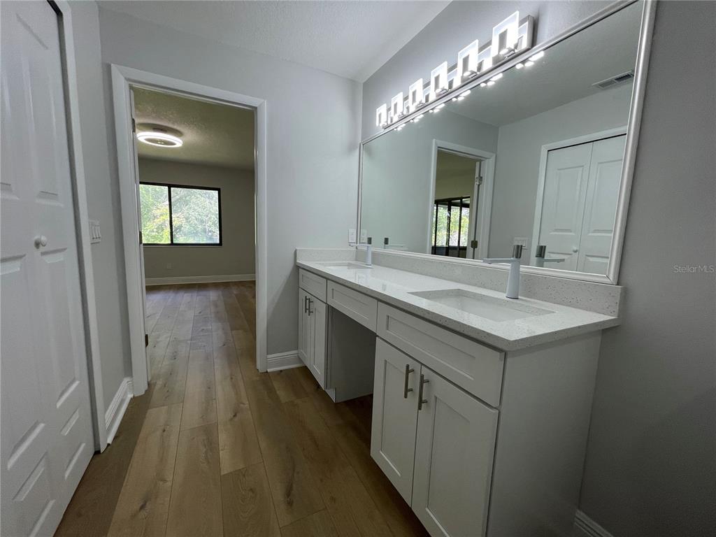 5395 Vineland Road, Unit S Orlando, FL 32811 - Photo 20 of 30 a bathroom with a sink a vanity and a mirror
