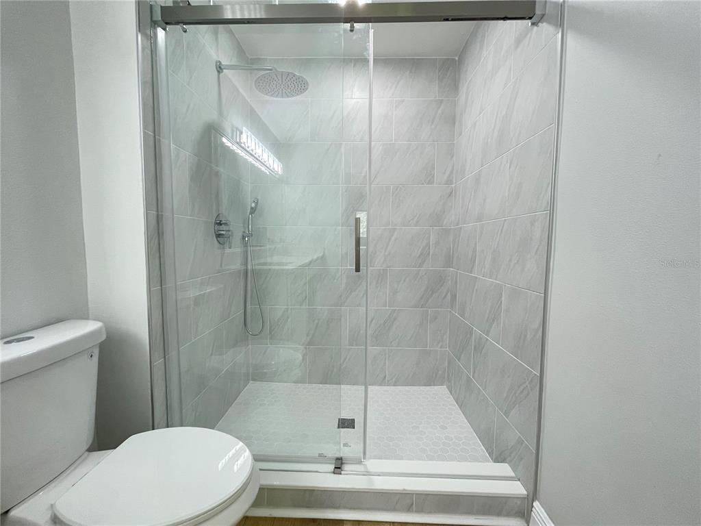 5395 Vineland Road, Unit S Orlando, FL 32811 - Photo 21 of 30 a bathroom with a shower and a toilet