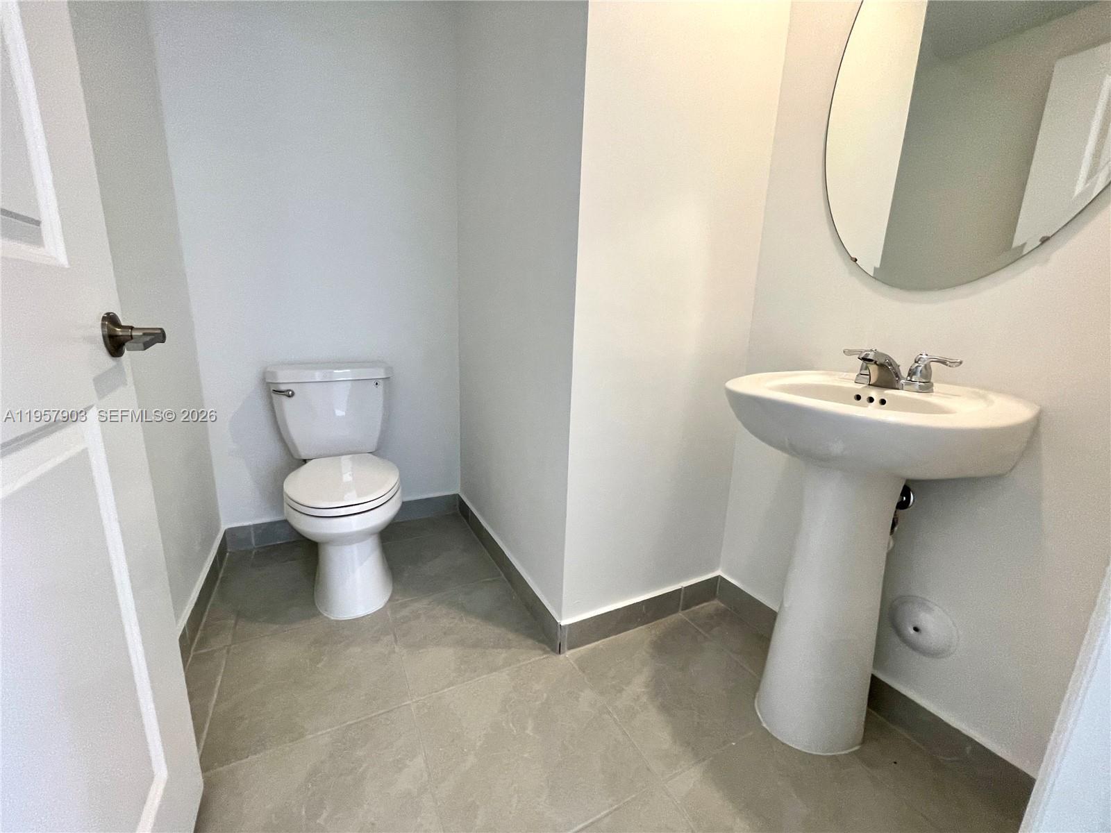 23110 Southwest 129th Place, Unit 23110 Miami, FL 33177 - Photo 13 of 29 a bathroom with a sink toilet and a mirror