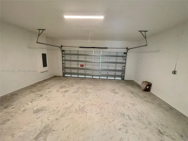 a view of an empty room and a garage