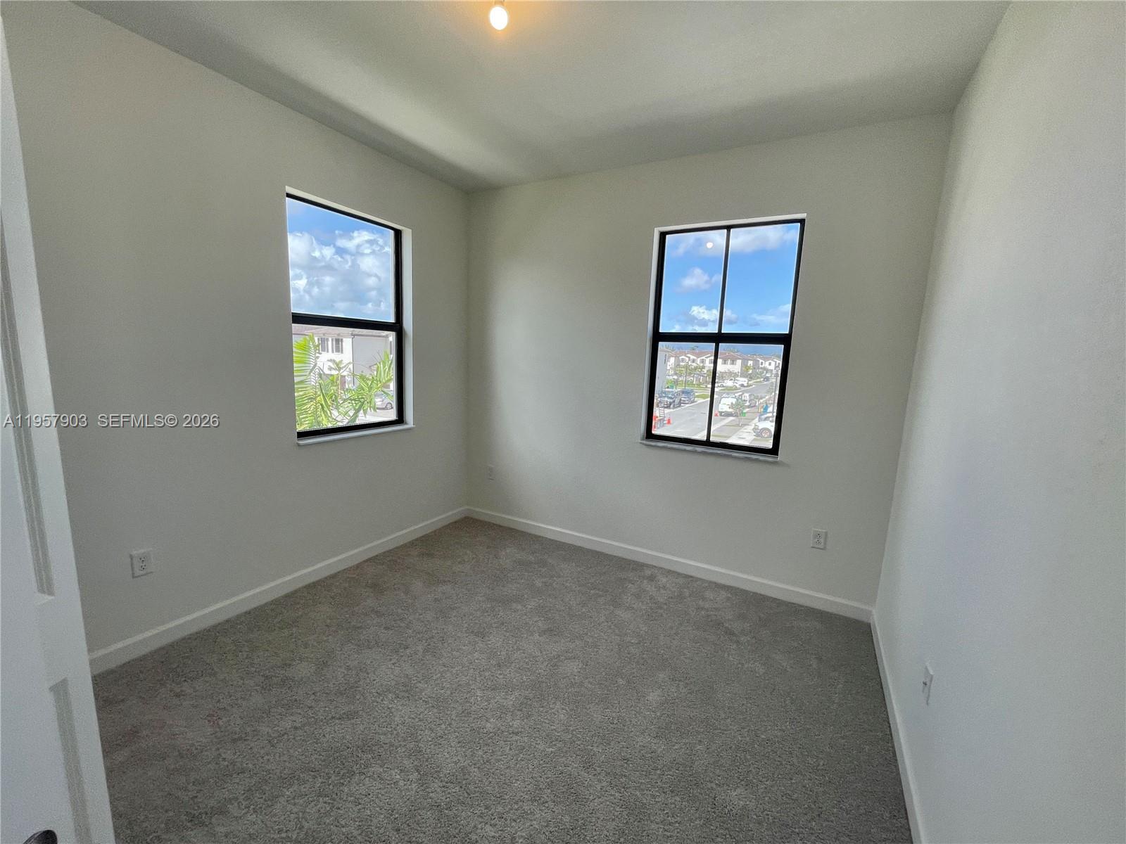 23110 Southwest 129th Place, Unit 23110 Miami, FL 33177 - Photo 16 of 29 an empty room with windows and closet