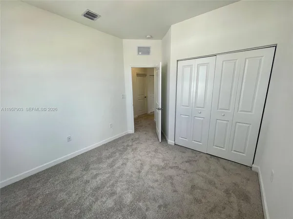 an empty room with closet area