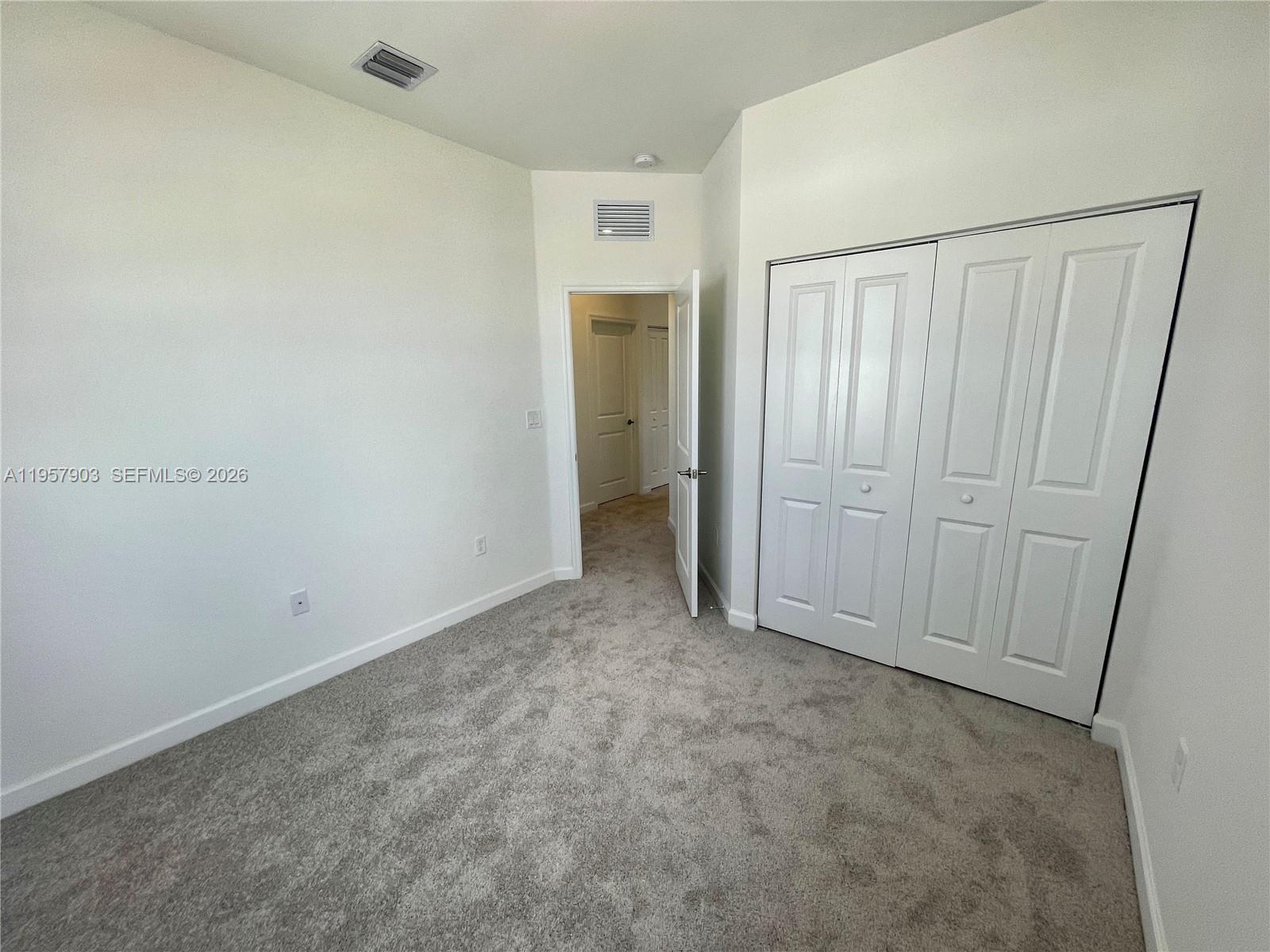 23110 Southwest 129th Place, Unit 23110 Miami, FL 33177 - Photo 17 of 29 an empty room with closet area