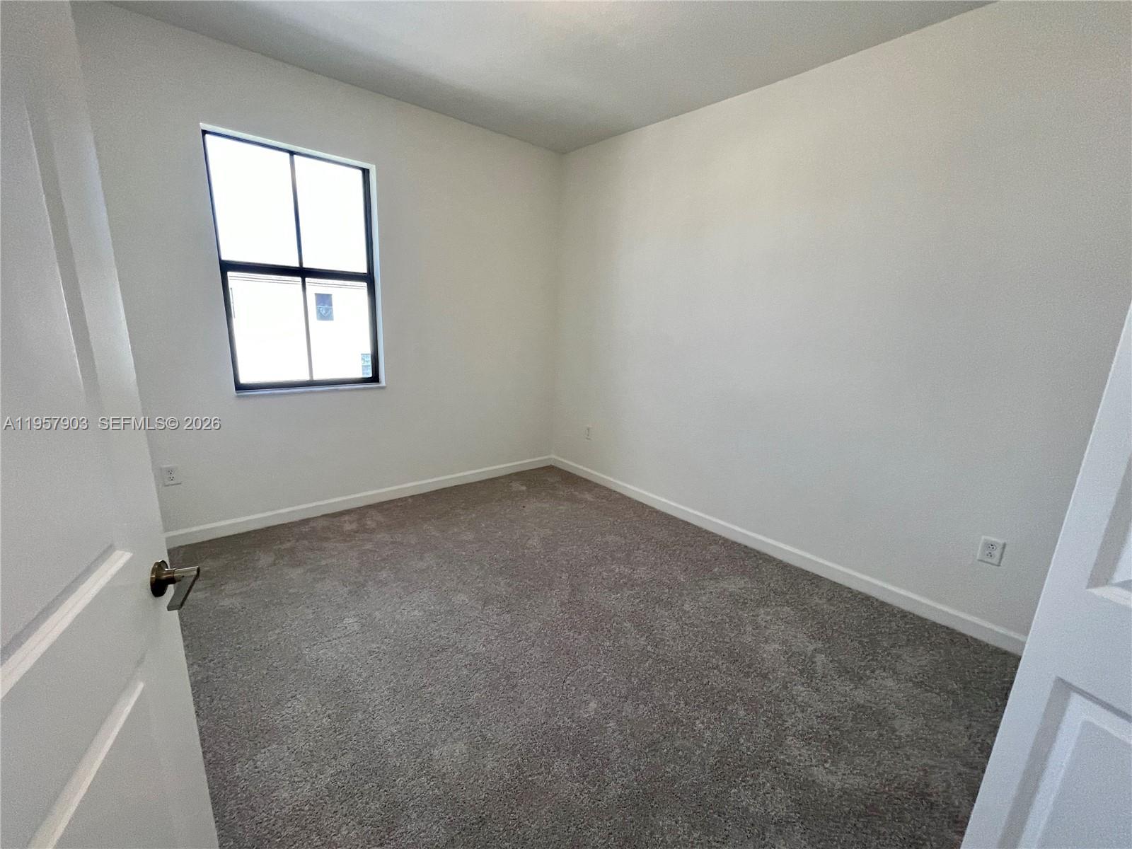 23110 Southwest 129th Place, Unit 23110 Miami, FL 33177 - Photo 19 of 29 an empty room with a window