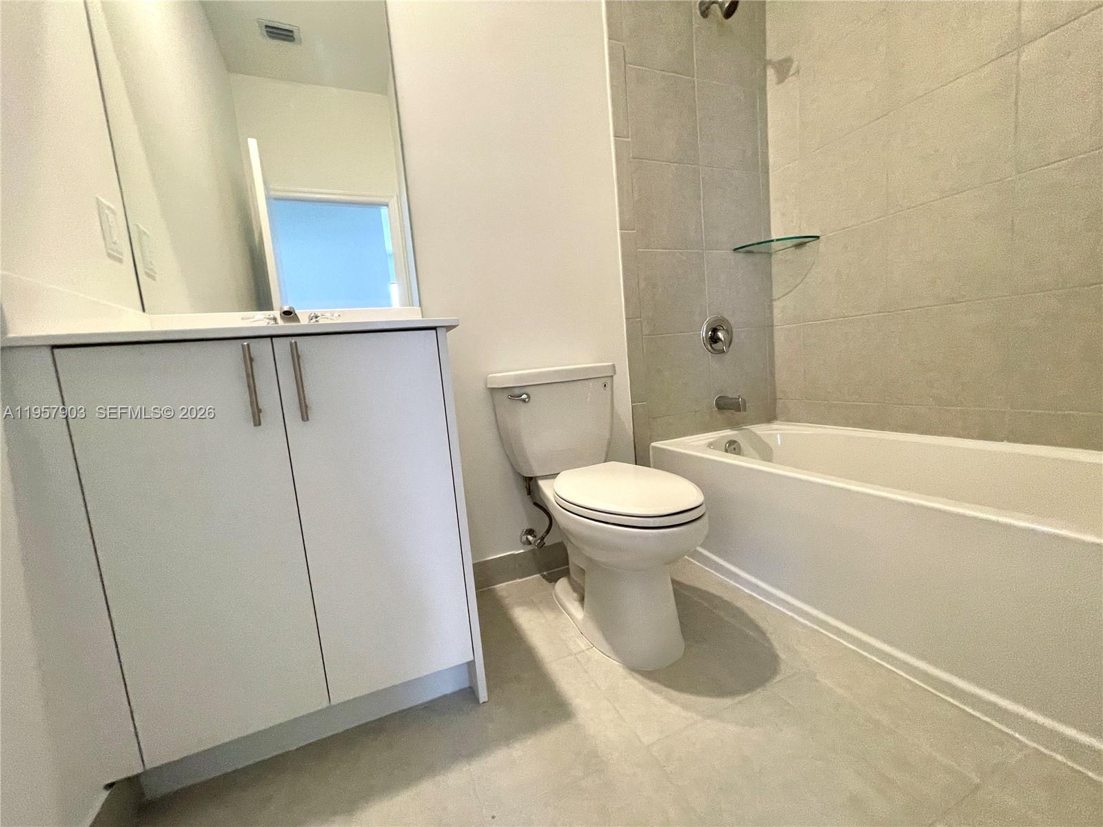 23110 Southwest 129th Place, Unit 23110 Miami, FL 33177 - Photo 27 of 29 a bathroom with a toilet and a shower