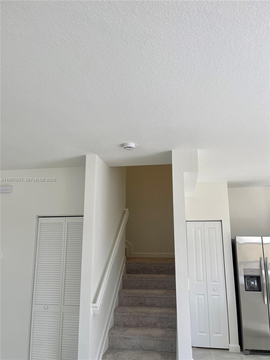 23110 Southwest 129th Place, Unit 23110 Miami, FL 33177 - Photo 29 of 29 a view of a hallway with a refrigerator