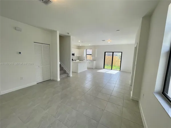 a view of an empty room and fire place