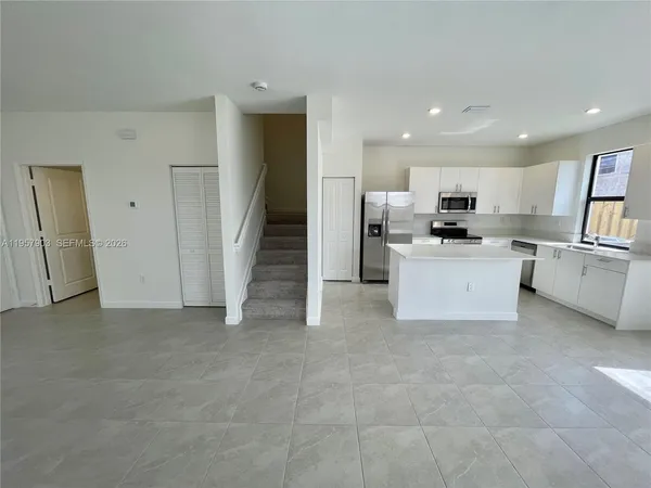 a view of a kitchen with a sink cabinets and a living room