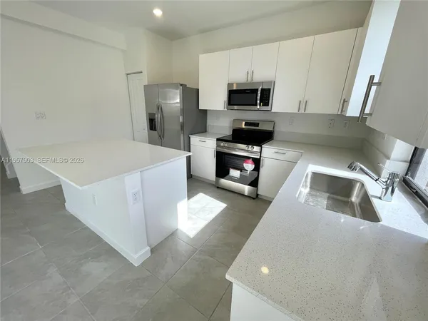 a kitchen with a sink a stove and refrigerator