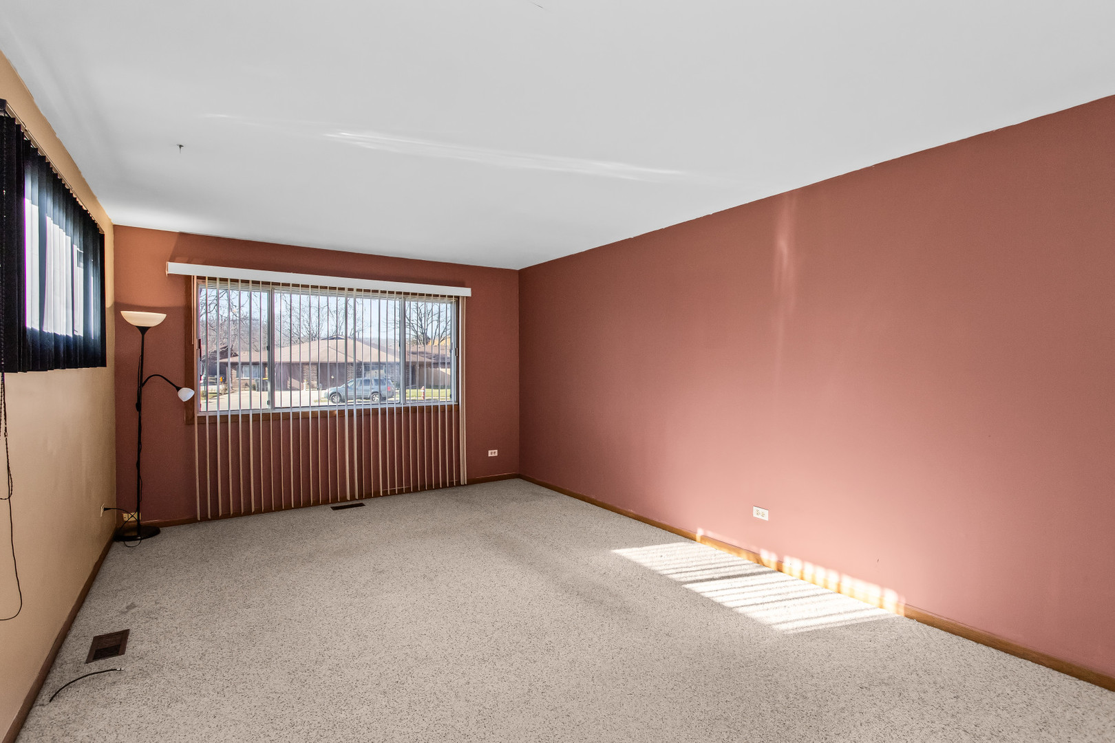 134 Virginia Court Streamwood, IL 60107 - Photo 3 of 25 an empty room with wooden floor and windows