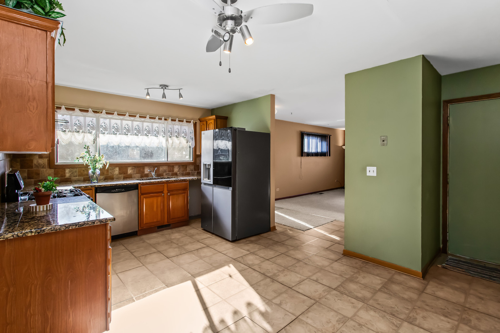 134 Virginia Court Streamwood, IL 60107 - Photo 7 of 25 a kitchen with refrigerator and window