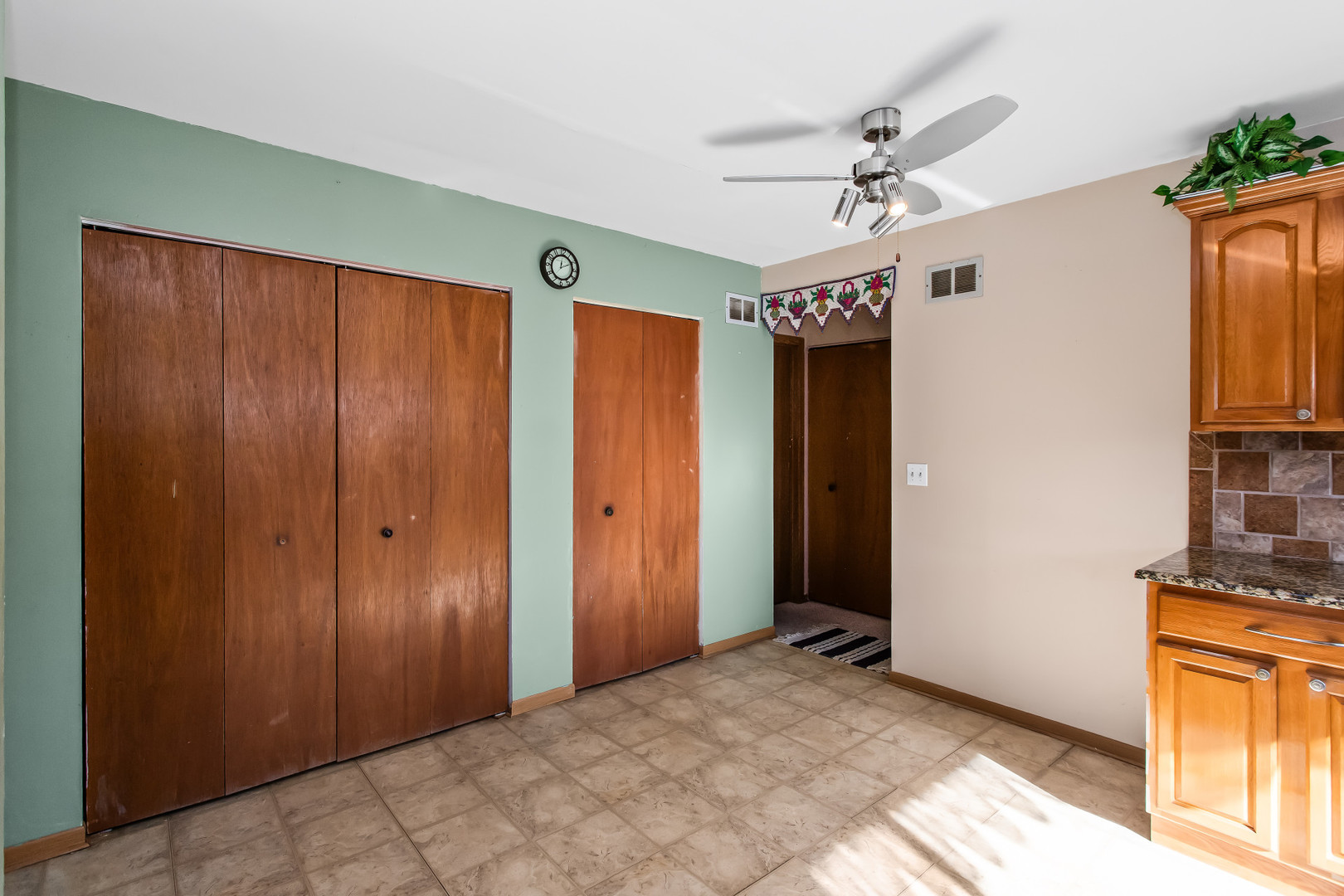 134 Virginia Court Streamwood, IL 60107 - Photo 8 of 25 a view of a livingroom with a chandelier fan and a window
