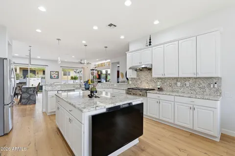 a kitchen with stainless steel appliances granite countertop a stove and a sink