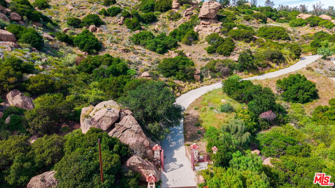 22001 Santa Susana Pass Road Chatsworth, CA 91311 - Photo 12 of 13 an aerial view of a house with a yard and garden