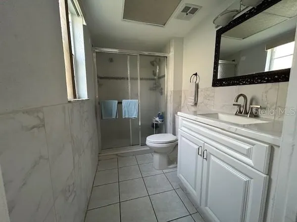 a bathroom with a sink a toilet and mirror