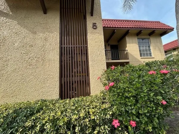 a view of a house with flower plants
