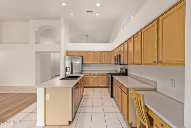 a kitchen with stainless steel appliances granite countertop a sink and cabinets