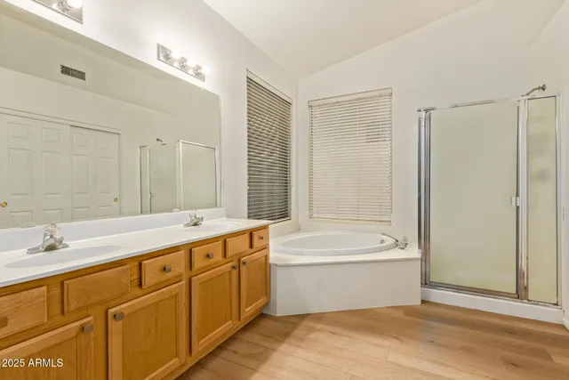 a bathroom with a tub sink and mirror