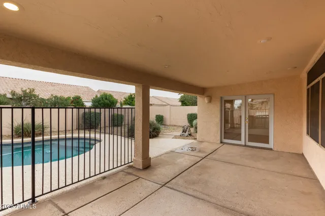 a view of a swimming pool with a yard