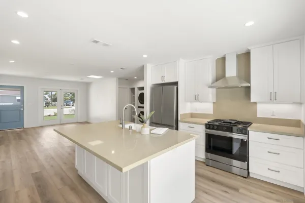 a kitchen with stainless steel appliances granite countertop a sink stove and refrigerator