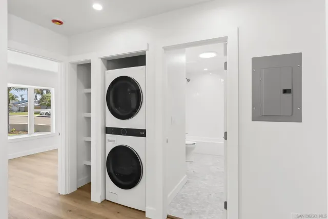 a view of a hallway with washer and dryer