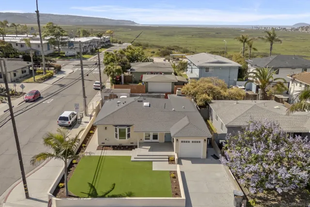an aerial view of a house with a ocean view