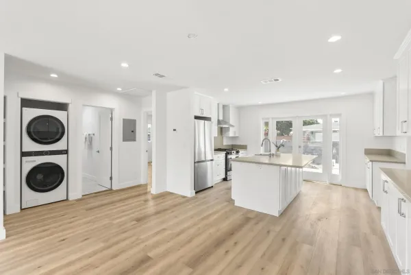 a view of a kitchen with cabinets and wooden floor