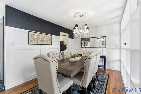a living room with furniture a rug and a bookshelf