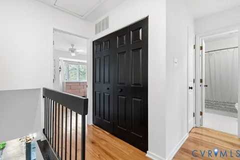 a bedroom with a bed a window and walk in closet