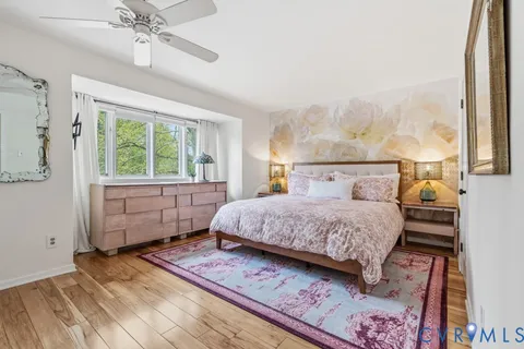 a bedroom with a bed and a painting on the wall