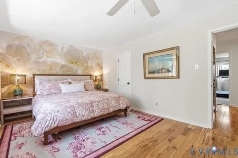 a bathroom with a granite countertop sink a toilet and mirror