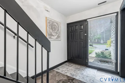 a view of entryway with stairs and wooden floor