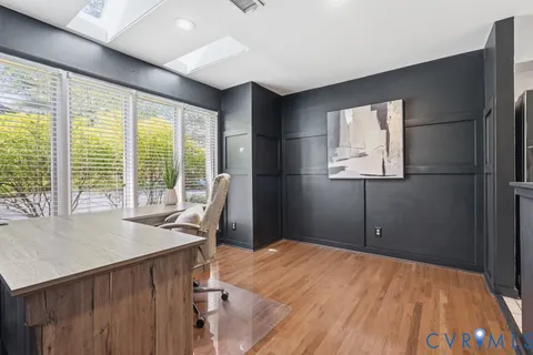 a workspace with furniture and wooden floor