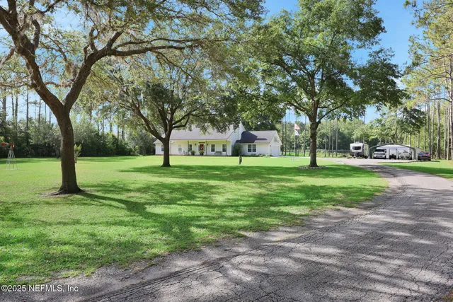 a view of green field with trees